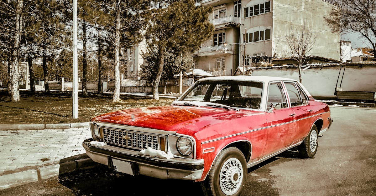 Red Chevrolet car parked on tree-lined street — C0281 brake pedal position code diagnosis for Chevy Sonic