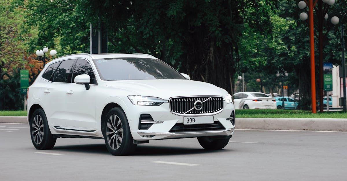 Modern white SUV on urban road — C0561 StabiliTrak code diagnosis and ground-strap fix for Buick Enclave